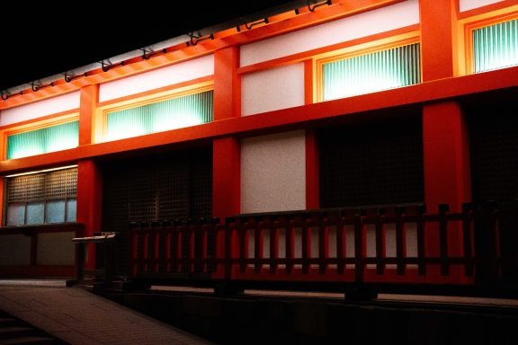Traditional architecture with vibrant orange accents and illuminated windows at night.