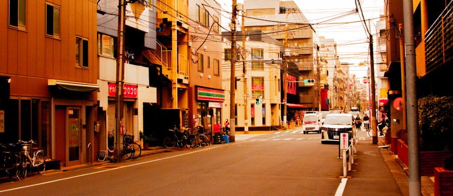 Empty street lined with colorful buildings and parked bicycles.