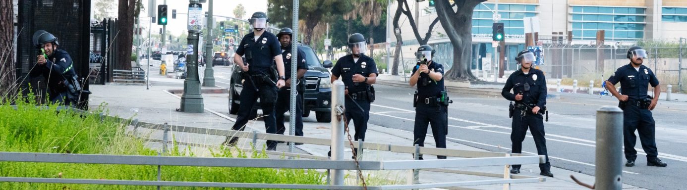 A group of police officers standing on a street in a city.